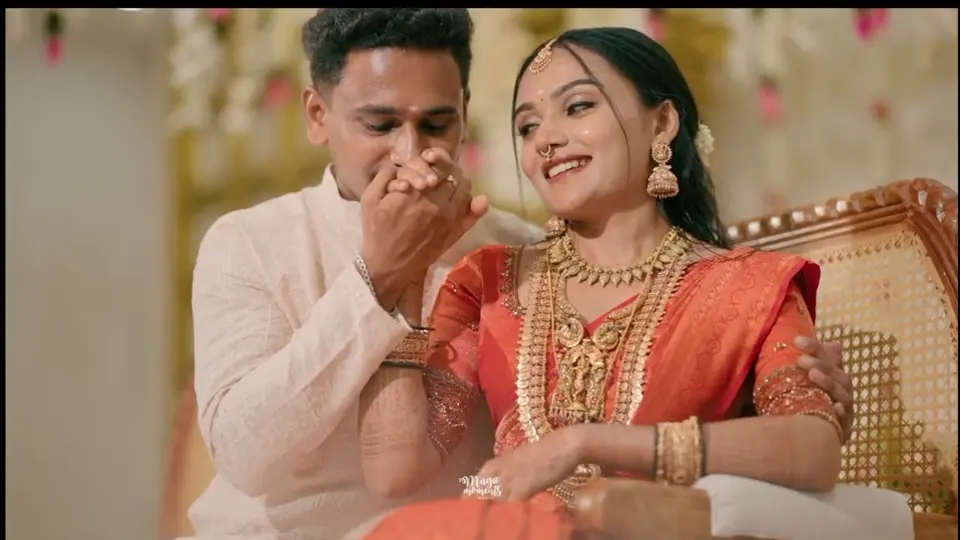 A smiling couple in traditional wedding attire