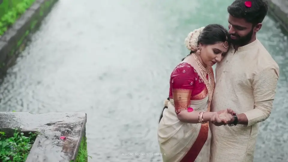 A wedding couple beside green waterside steps