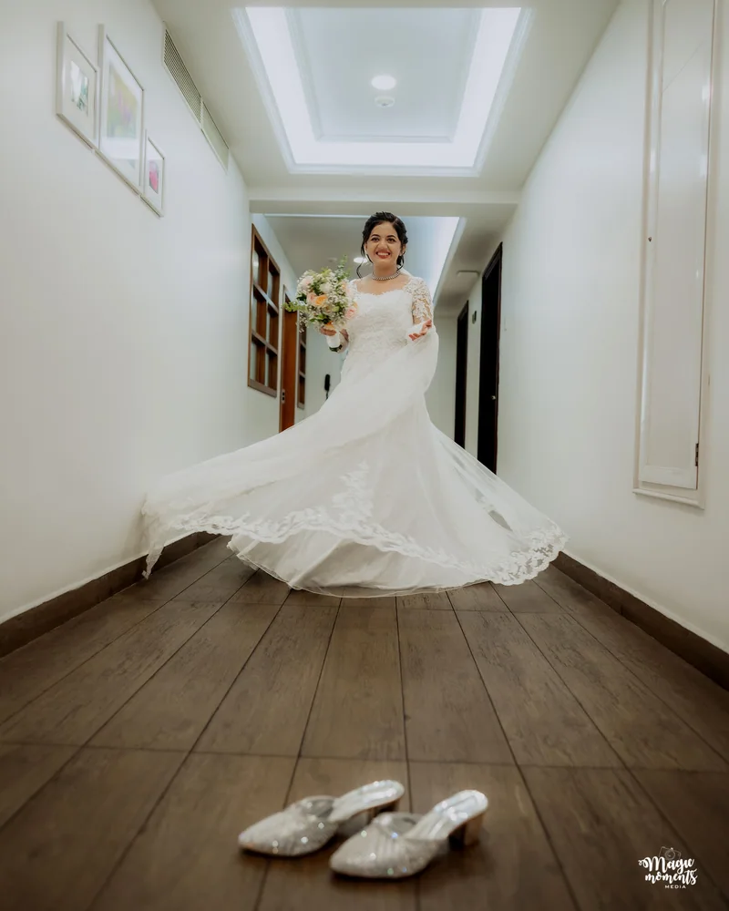 A bride twirling her wedding dress in a hallway