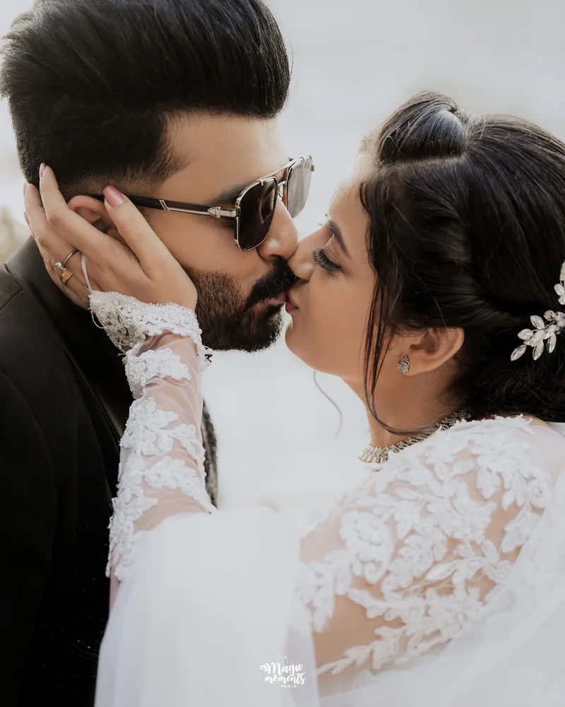 A bride and groom sharing a kiss outside