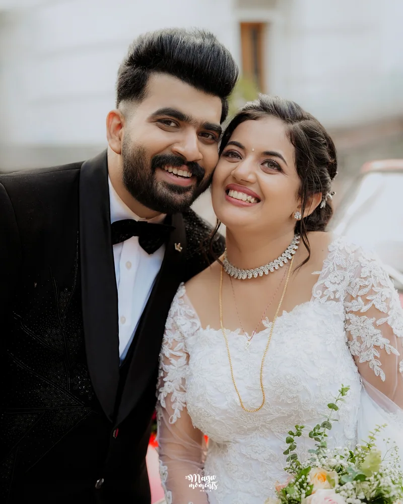 A bride and groom smiling together in a close portrait